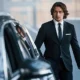 Executive approaching luxury car for corporate travel | Top Class Chauffeurs, business transportation, luxury service