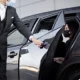 Chauffeur opening car door for client - Top Class Chauffeurs, luxury transportation, professional chauffeur service